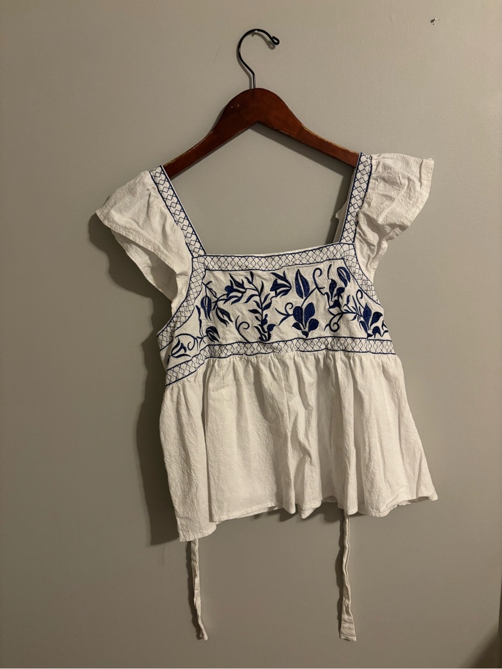 White Embroidered Peplum Top with Blue Floral Detail
